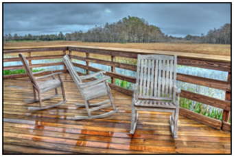Three rocking chairs on a wooden observatory deck at Grassy Waters Preserve, South Florida 