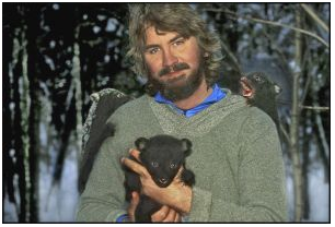 Portrait of photographer Raymond Gehman with three bear cubs on him