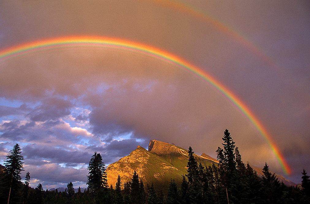 Rainbow over the Rocky Mountains in Banff, Canada, National Geographic photograph by Raymond Gehman