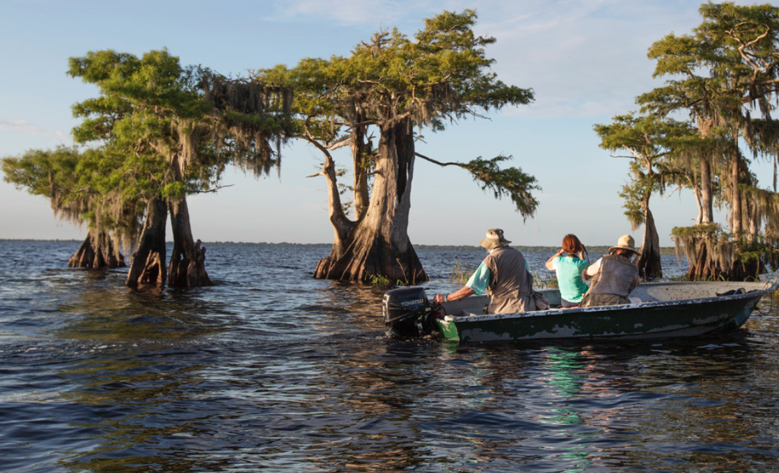 Florida photography workshop participants in a boat with Raymond Gehman in the Everglades